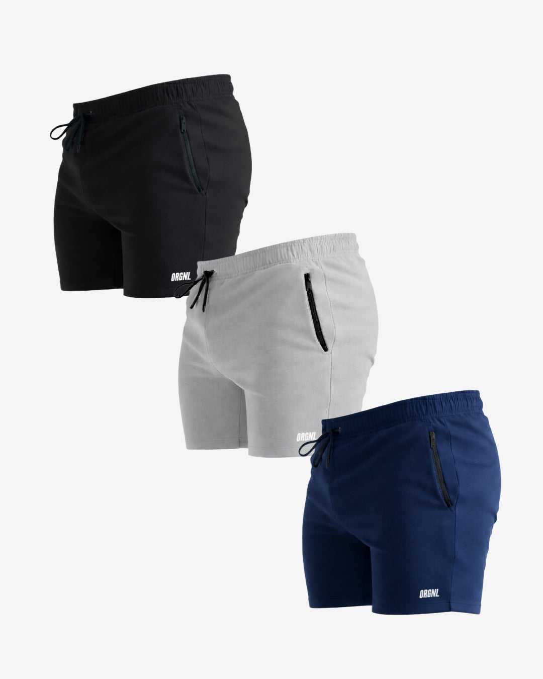 Three pairs of athletic shorts shown on a light gray background: black, light gray, and navy blue. Each pair has an elastic waistband, drawstring, zip pocket, and a small white logo near the lower hem.